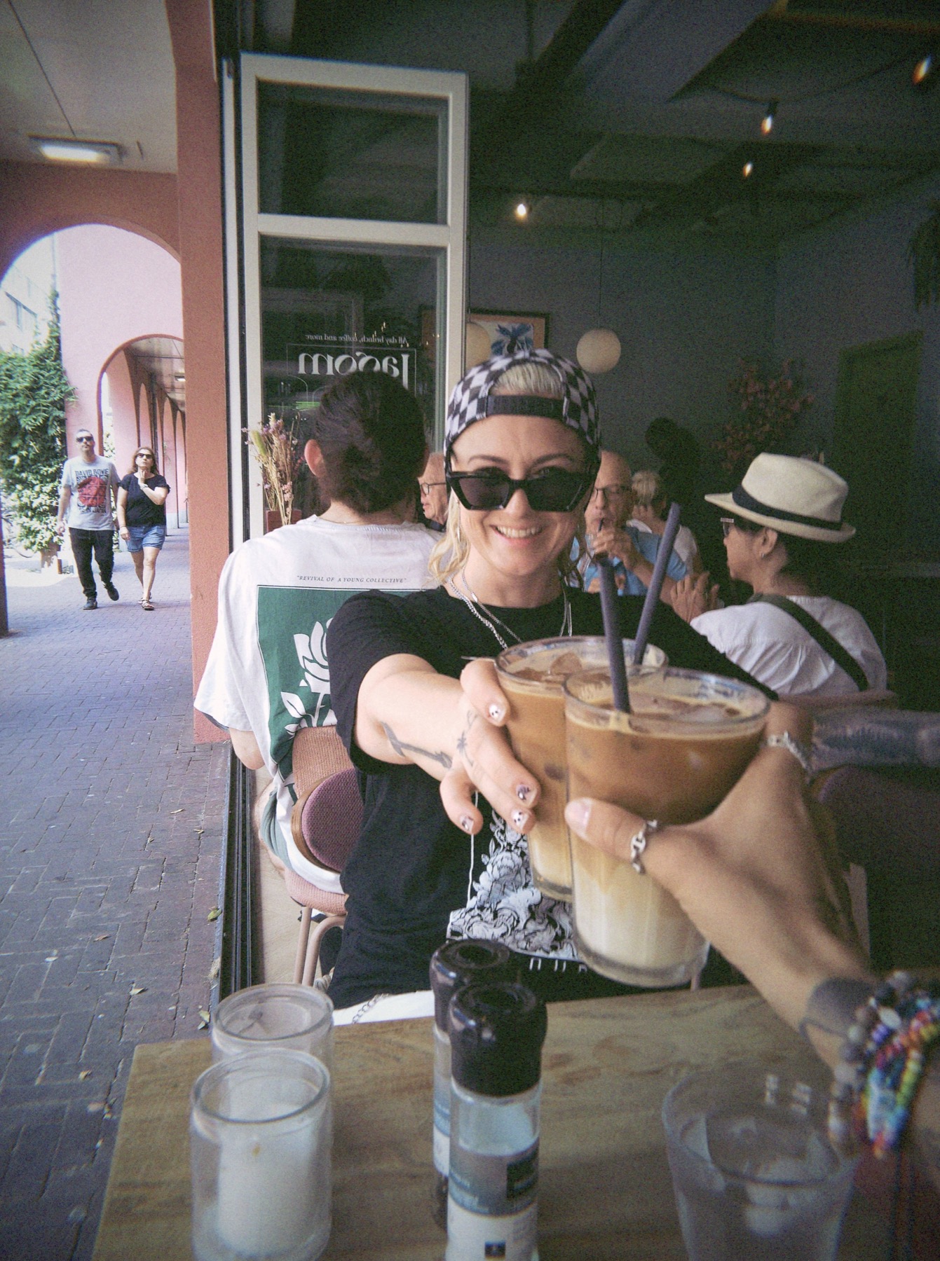 Friends raising iced coffees together